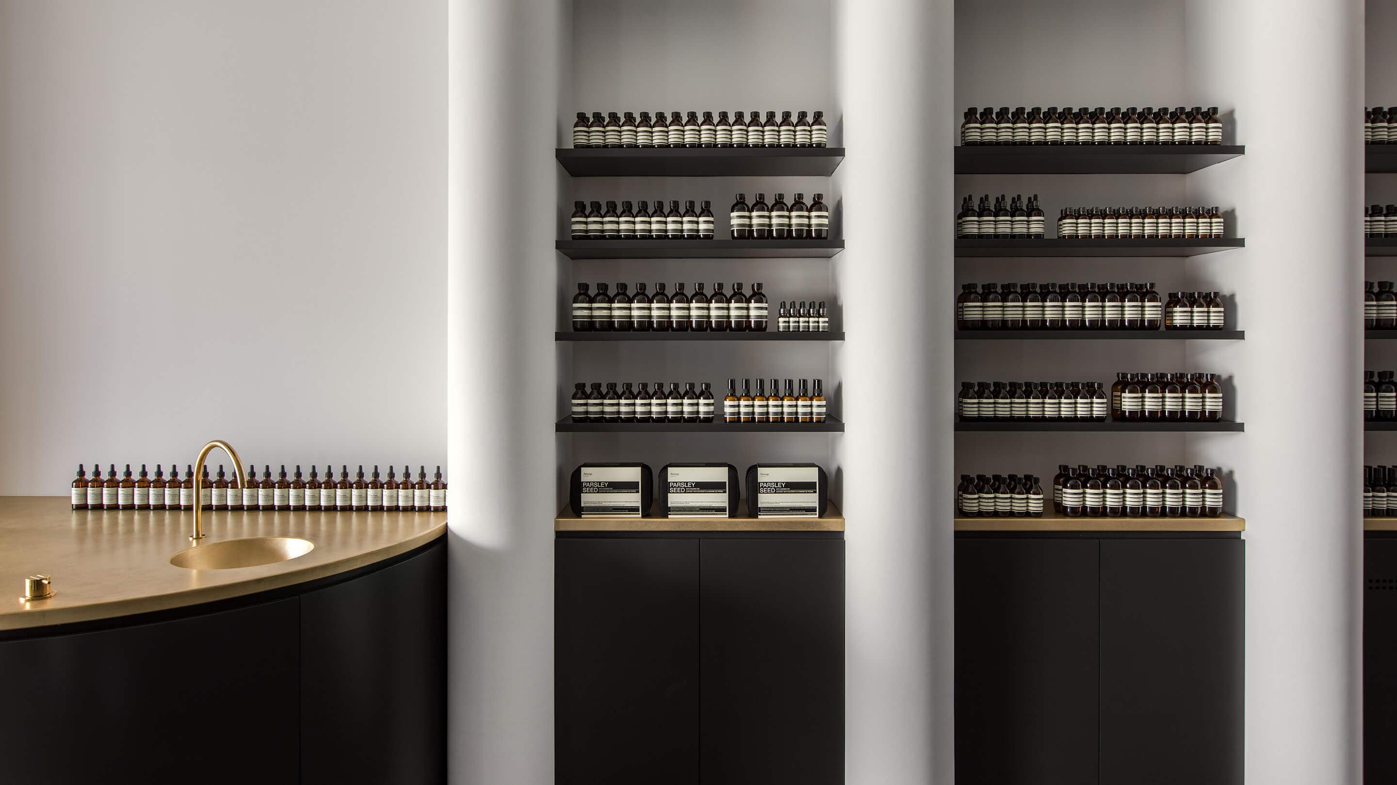 Aesop Studio City store interior, featuring a gold-coloured metal basin.