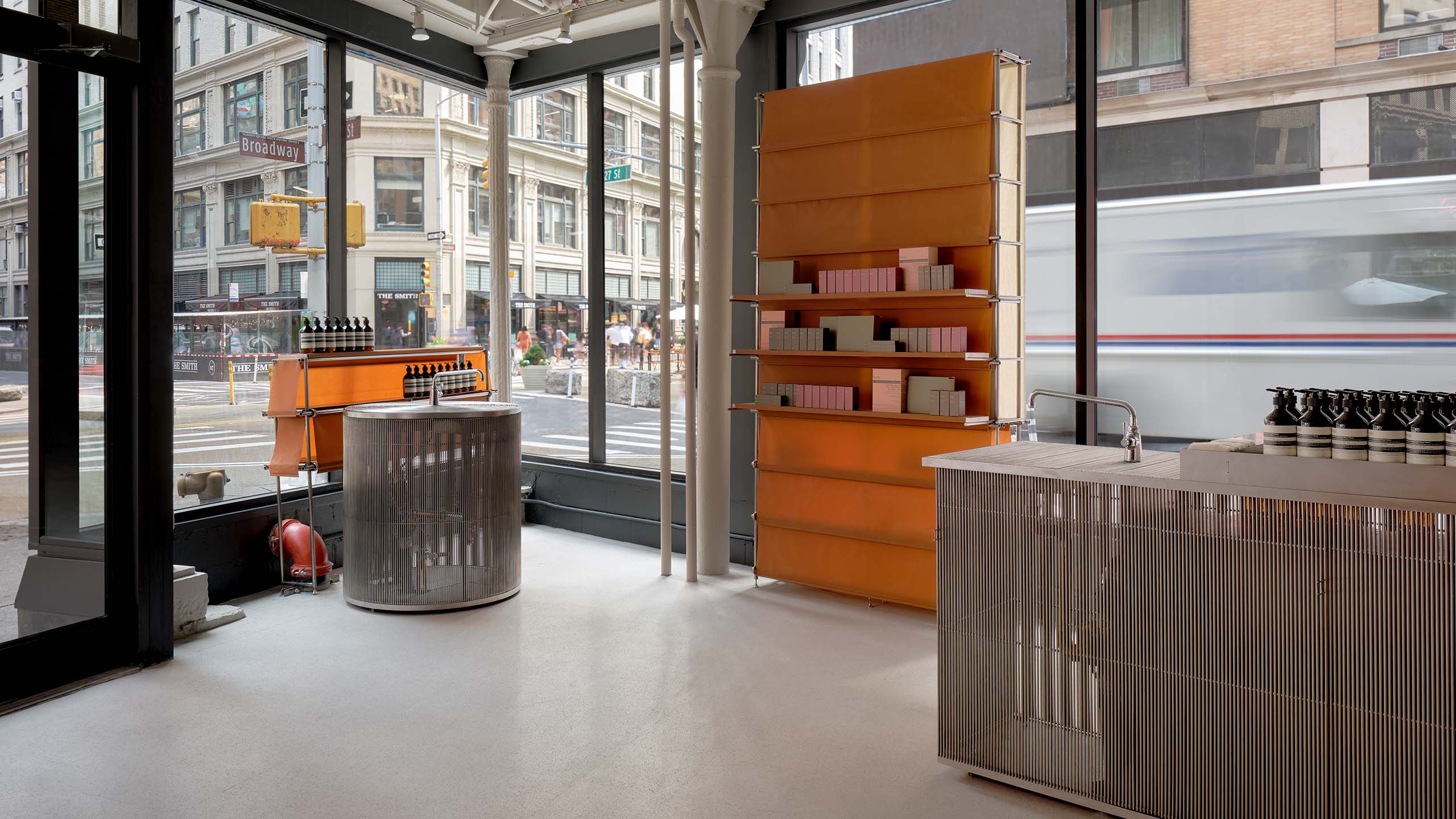 store interior looking out windows onto city streets with countertop sinks in the foreground