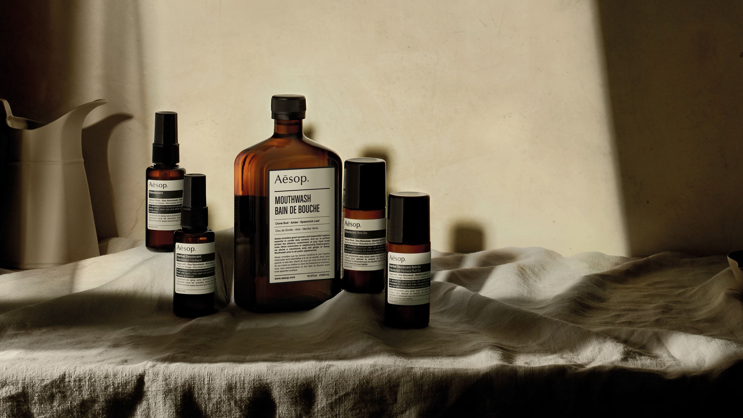 Aesop products on linen cloth and with beige background