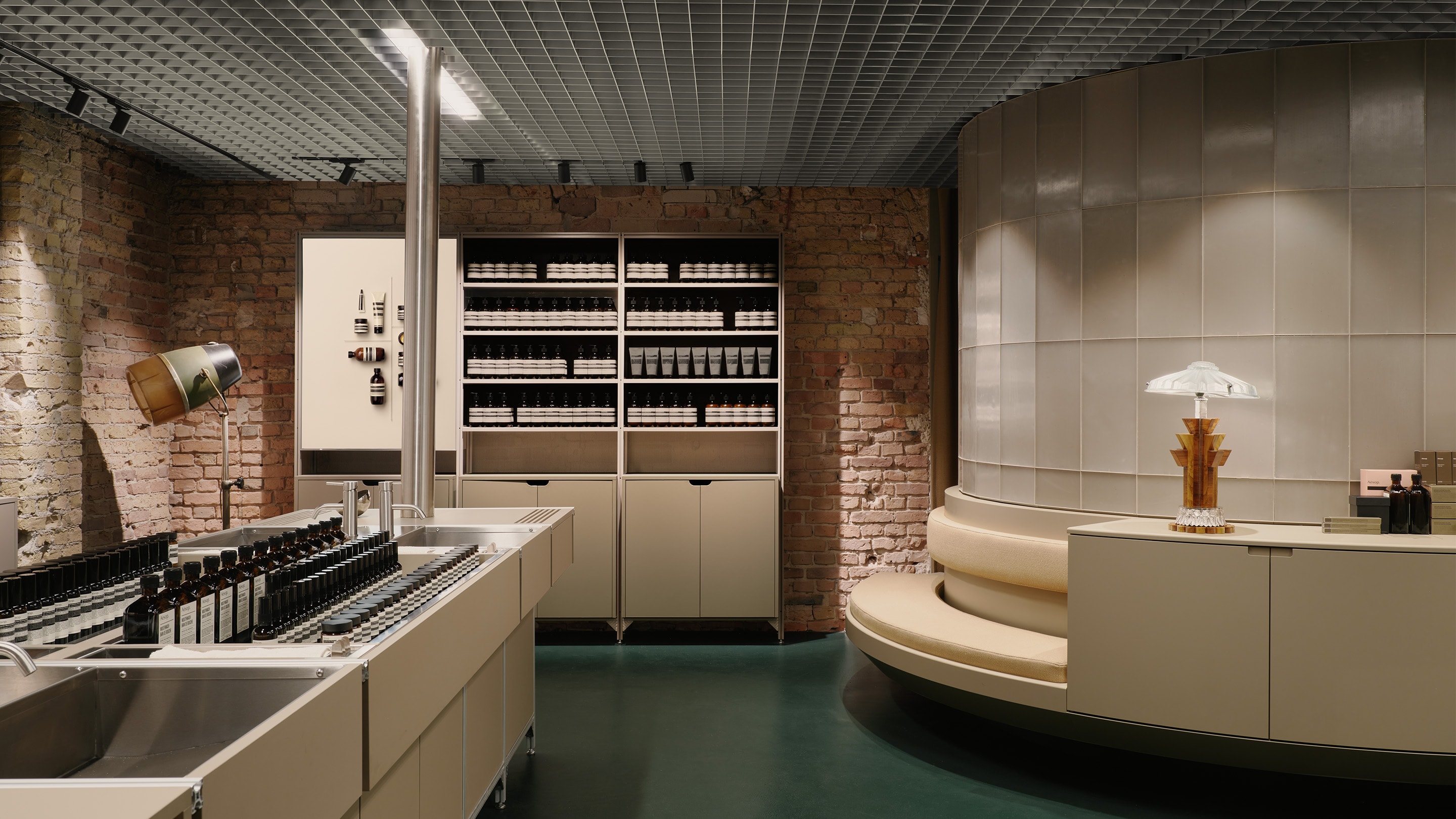 Aesop Kurfurstendamm store interior featuring bench seat, basin and Aesop product shelve displays