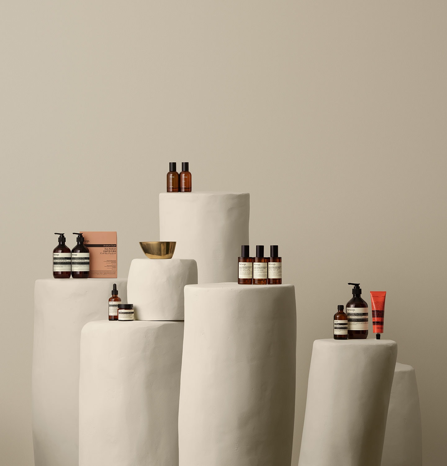 Aesop products placed on a white stone pillars