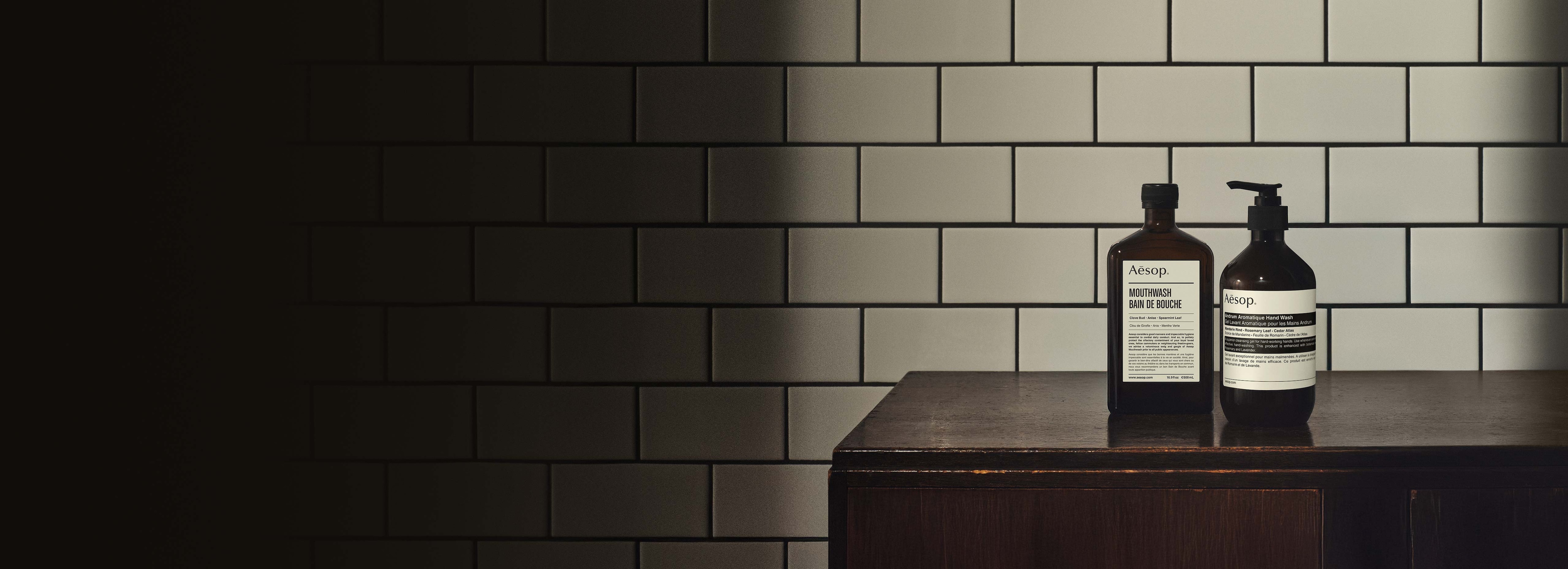 Andrum Aromatique Hand Wash and Mouthwash on a wooden cabinet