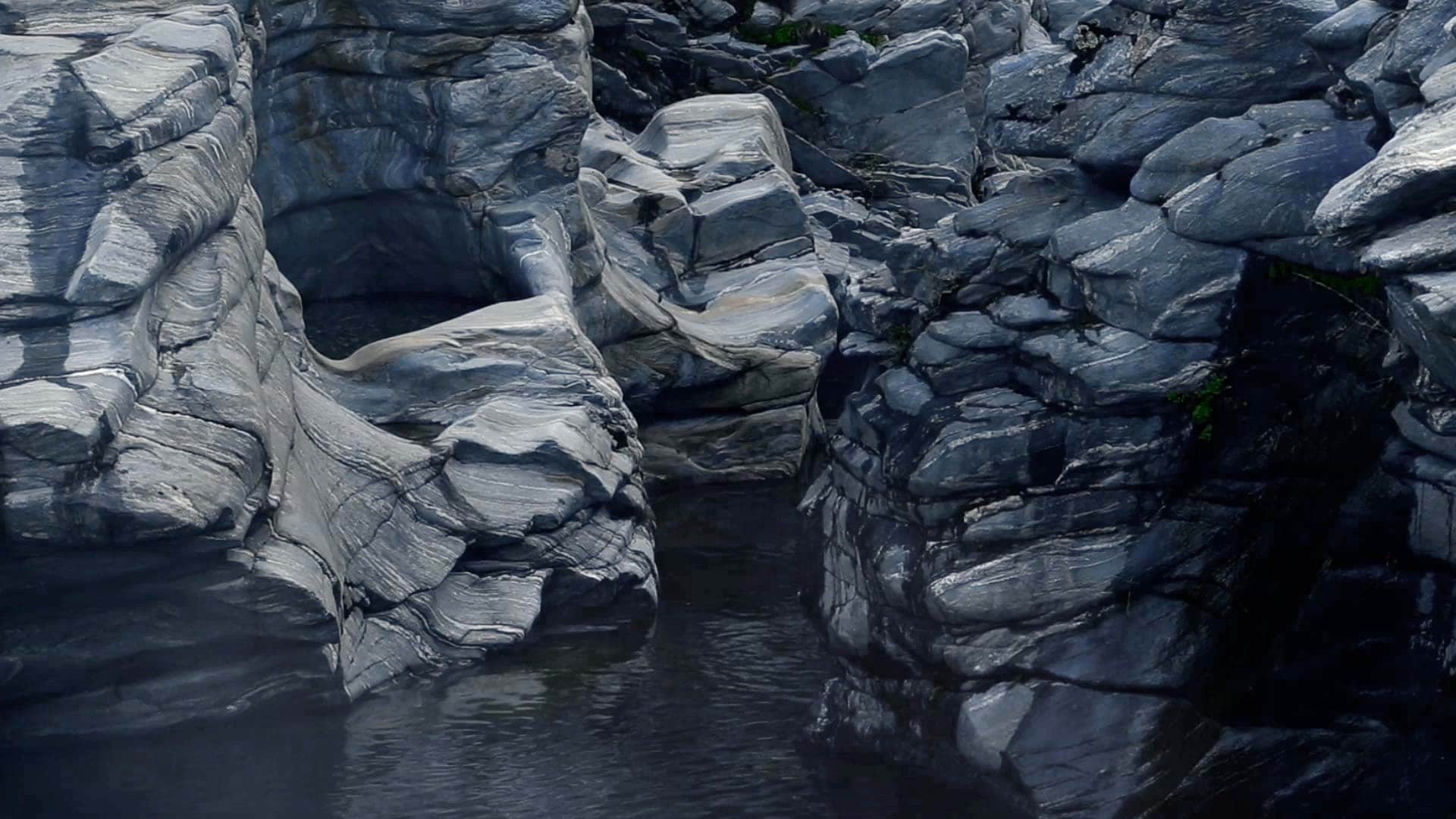 A smokey mist floats over rock formations. 