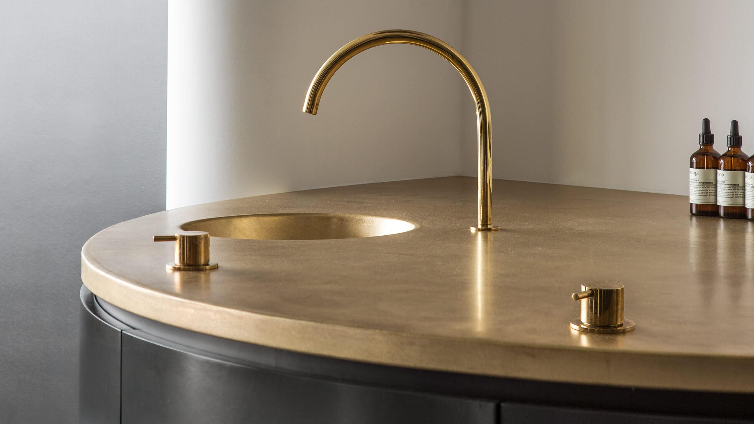 A close-up shot of the golden-topped basin inside Aesop Studio City.