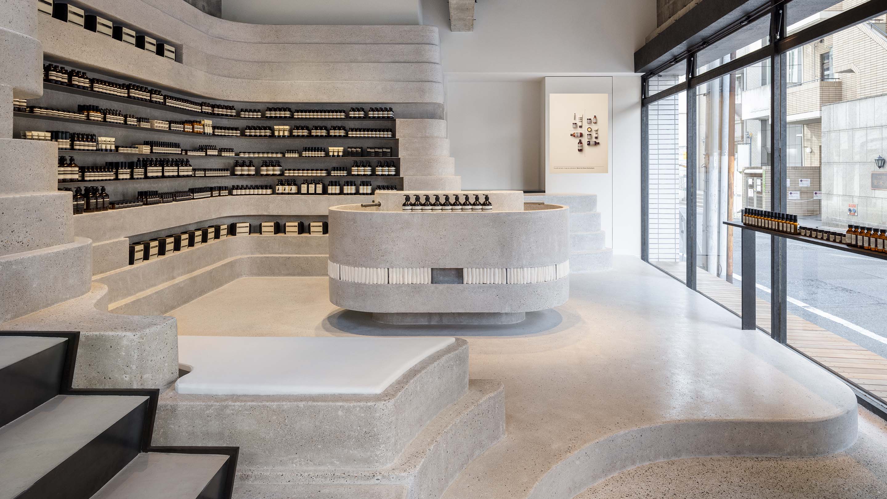Aesop Hiroshima store interior design with concrete walls, floor, counter and stairs