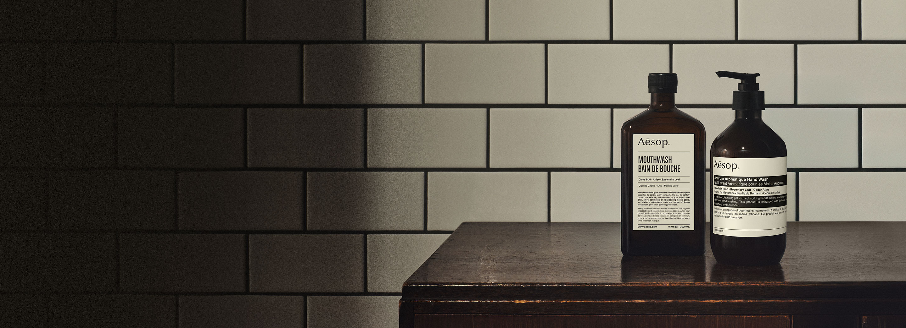 Mouthwash and Andrum Aromatique Hand Wash on a wooden surface, in a white tiles background