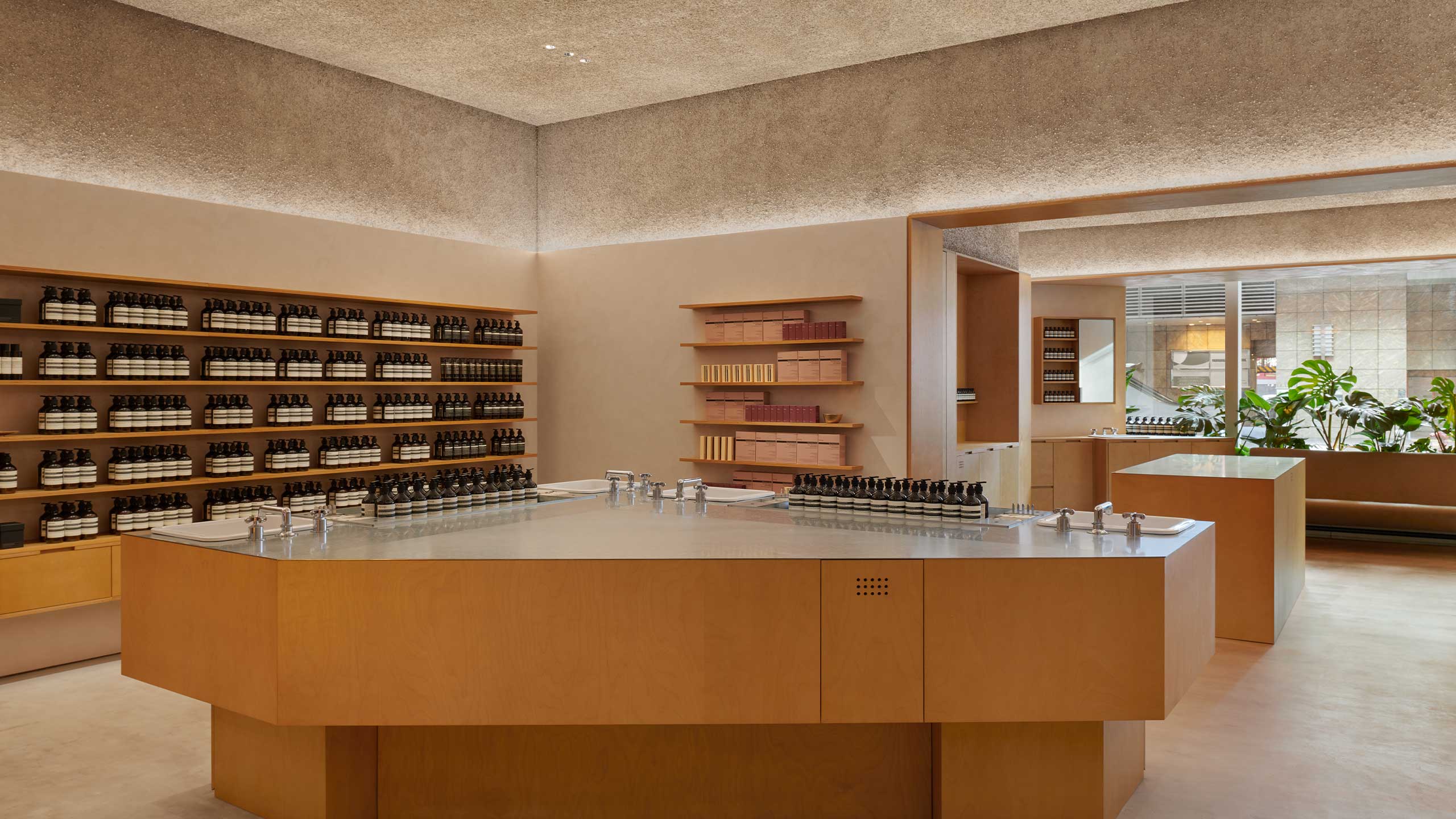 Aesop Langham Place interior with a trio of ceramic basins set into a timber structure