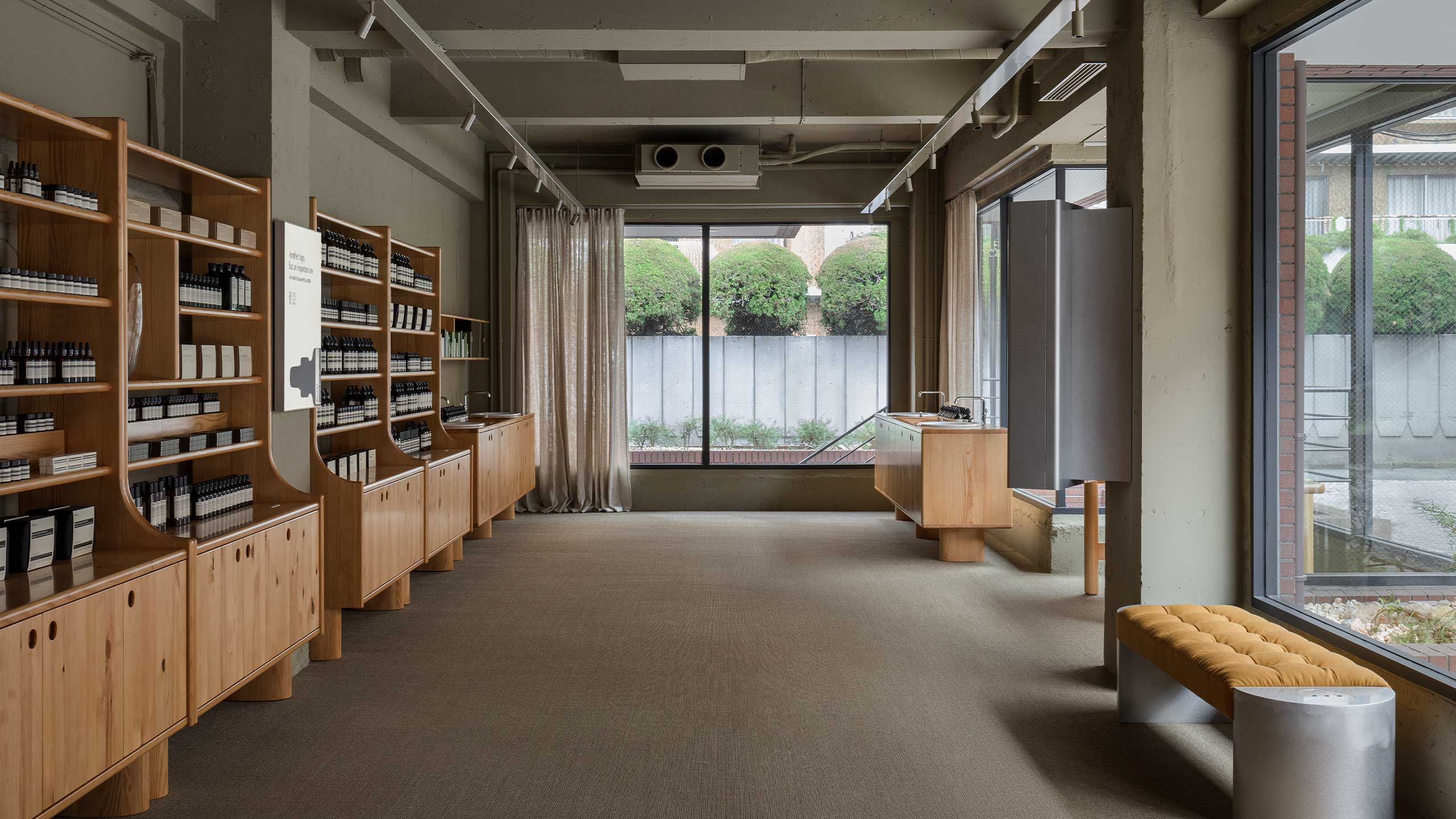 The ample natural light that pours in through the windows, and the quartet of basins that sit in the front corner while vintage wooden seats at the other corner