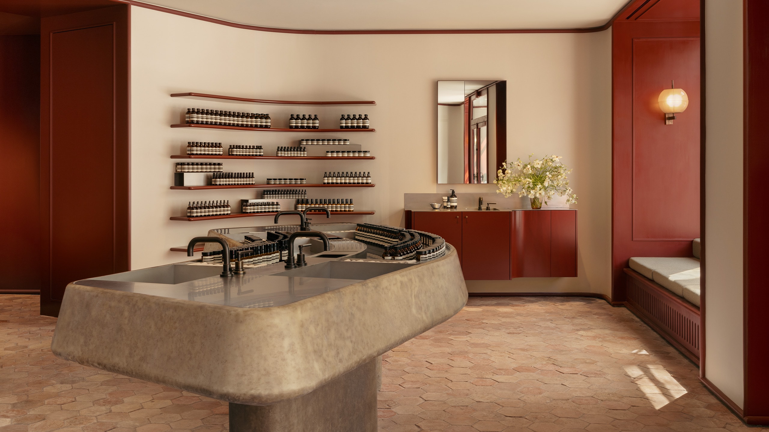Aesop Avenue des Ternes store interior, main sculptural stone basin, product display shelving and separate mini basin for demonstrations.