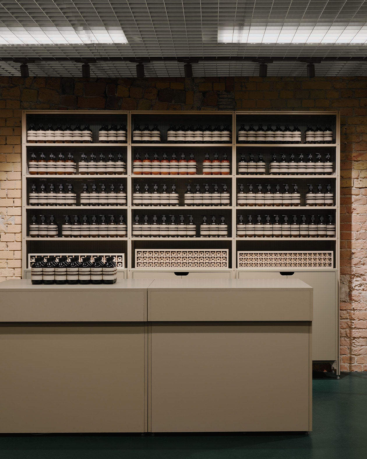 Aesop Kurfurstendamm store product display featuring rows of amber bottles on shelving