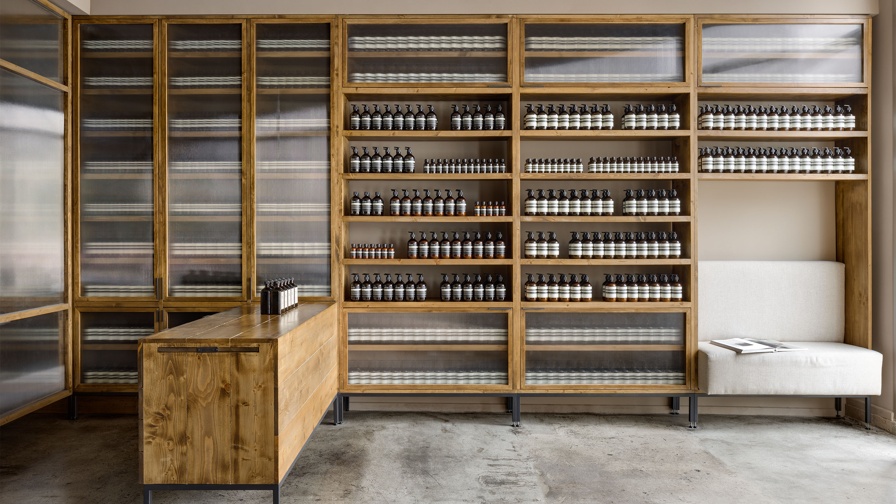 Store interior; featuring contrasting wooden shelving and countertops