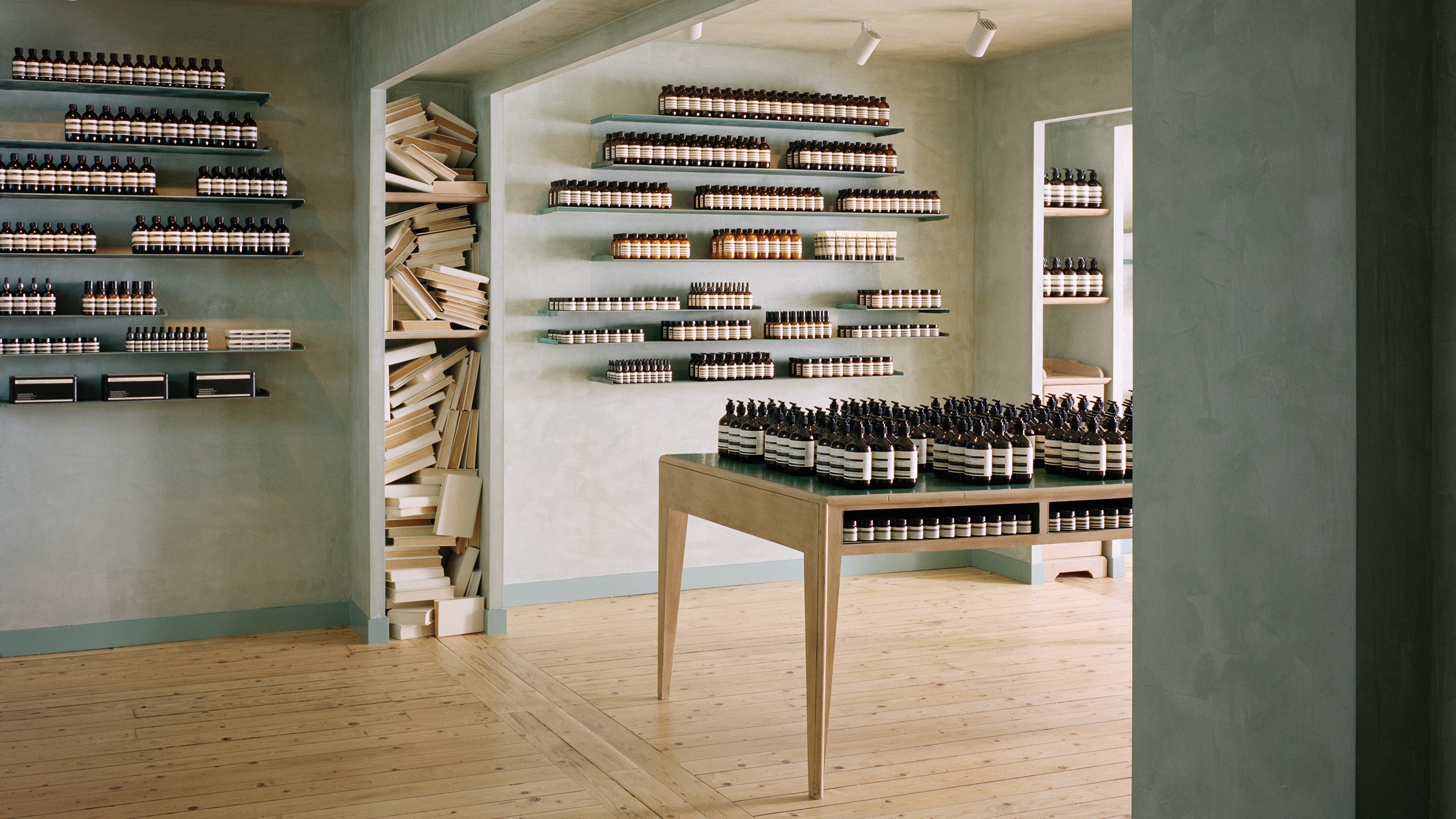 Aesop Brighton interior featuring blue walls and an installation of books.