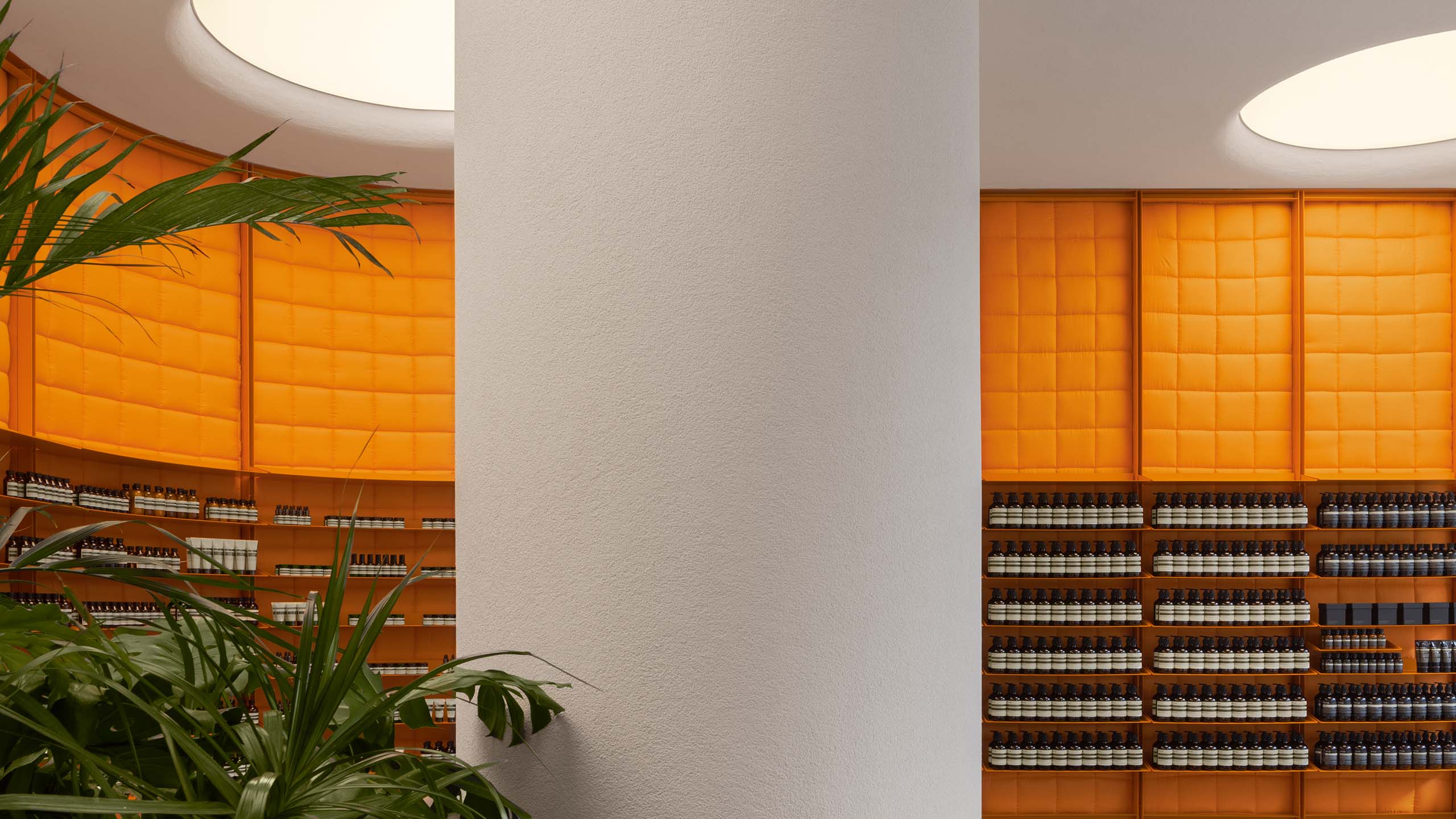store interior with orange product wall and white central column